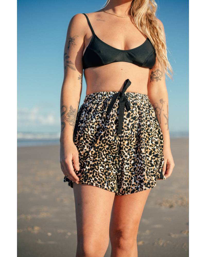 Model with surfboard and shorts
