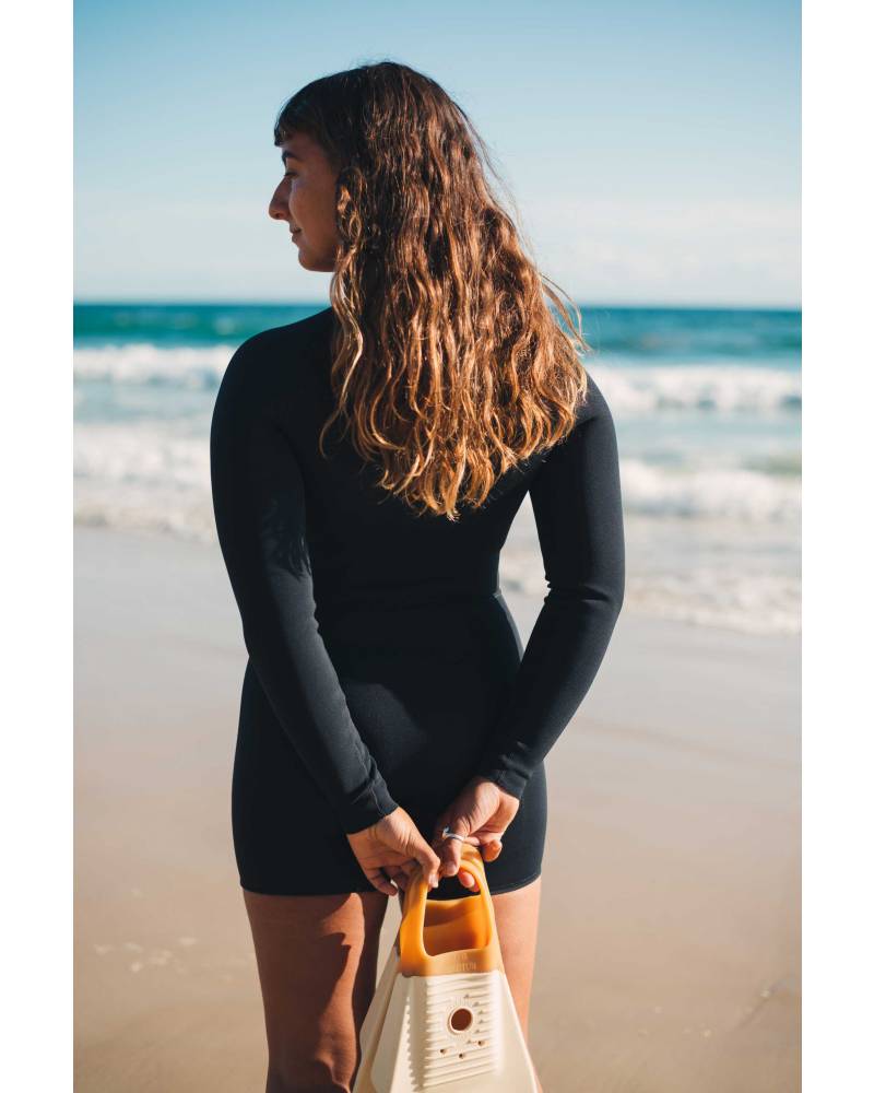 Wetsuit on beach shading eyes