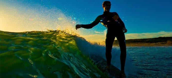 Longboarder noseriding at sunset