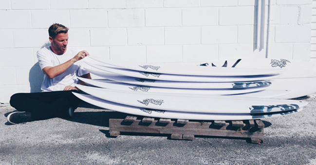 mitch crews with his stacey surfboard quiver